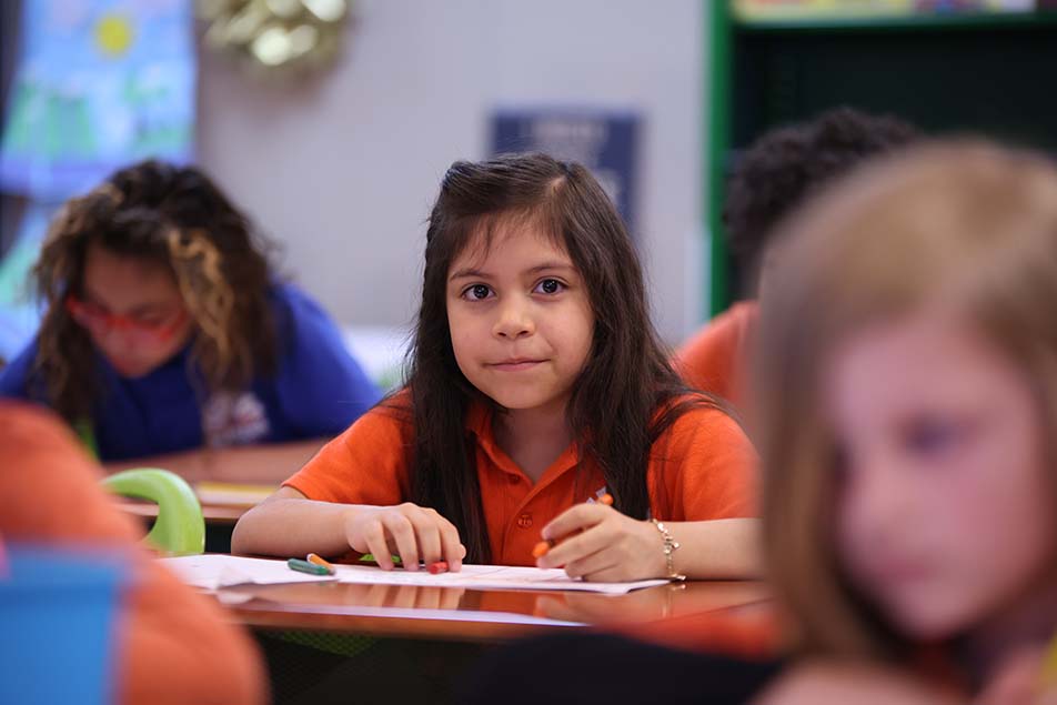 students and teacher working in classroom