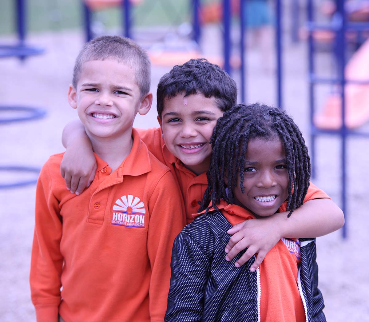 Teacher or school staff member warmly interacting with a student outside