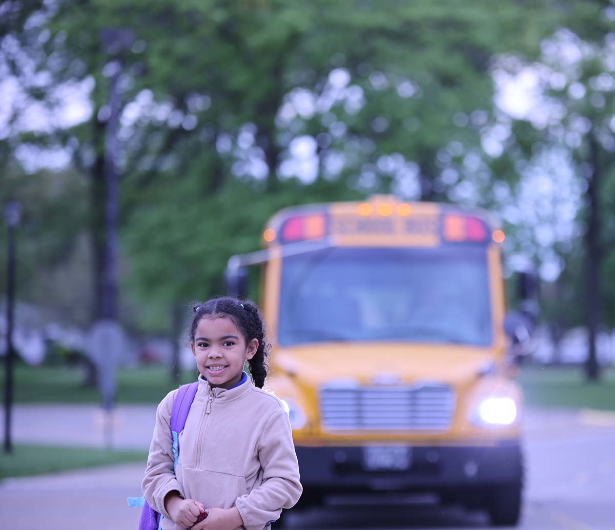 Smiling children together outdoors.